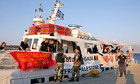 Greek coaGreek coastguards stand in front of the Canadian boat Tahrir