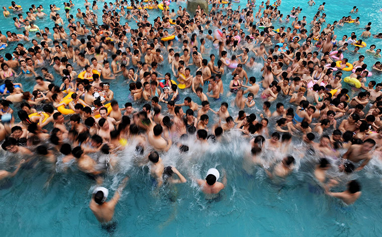 24 hours in pictures: People escape the heat at a swimming pool, China