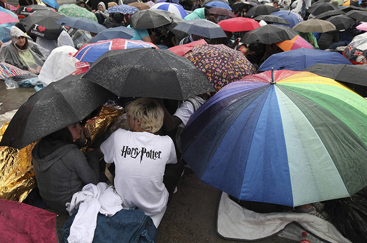 Camp Harry Potter: Harry Potter fans huddle under umbrellas during a downpour 