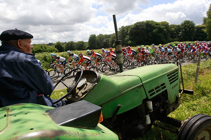 Tour de France stage 5: A farmer working his fields near Plougonver watches the peloton speed by 