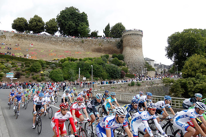 Tour de France Stage 6: The pack of riders snake past a fortified wall and out of town