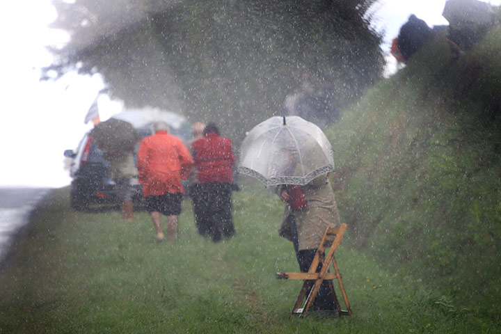 Tour de France Stage 6: Tour de France spectator waits in the rain