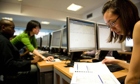 Student reading book at desk