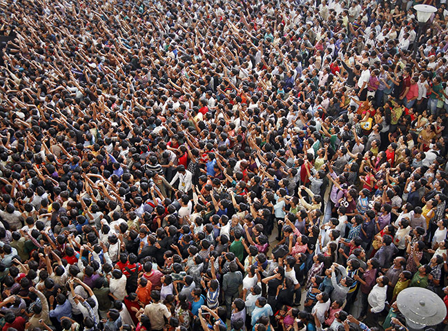 24 Hours in Pictures: Fans use their mobile phones to capture the crew of a new Bollywood film