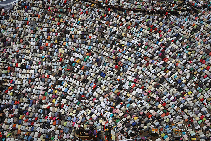24 Hours in Pictures: Egyptian demonstrators perform the weekly Friday prayer in Tahrir square