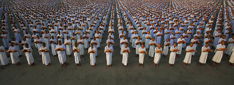 24 Hours in Pictures: Monks take part in a mass ordination ceremony for Buddhist Lent in Bangkok