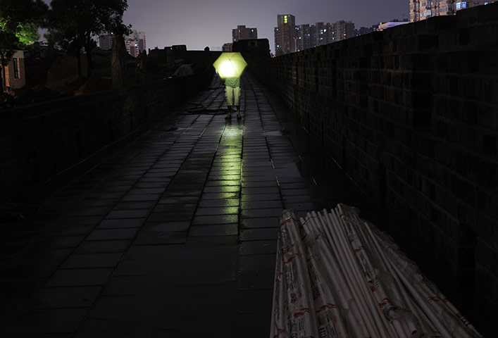 24 hours: Wuhan, China: A resident stands at the Gate of Wuchang Uprising 