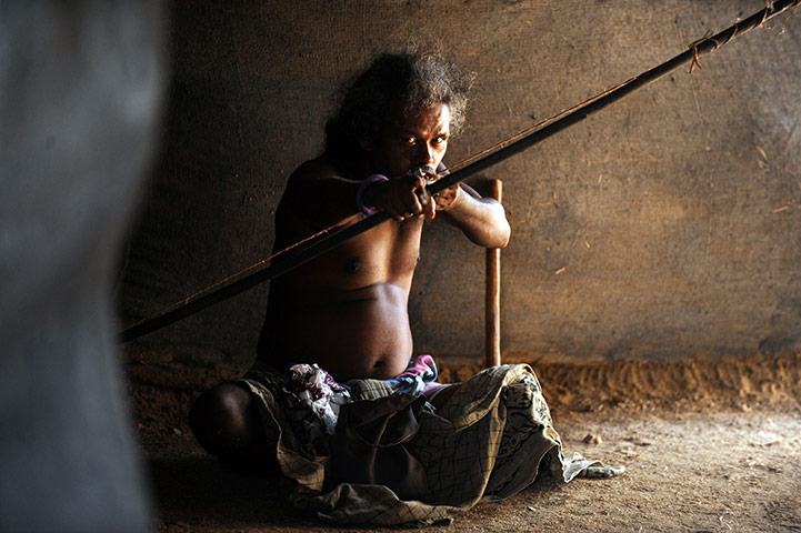24 hours: Vakarai, Sri Lanka: A Sri Lankan aboriginal (Veddha) aims his bow and arrow