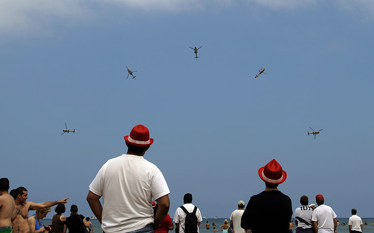 24 hours: Gijon, Spain: Spectators watch helicopters from the Spanish Air Force 