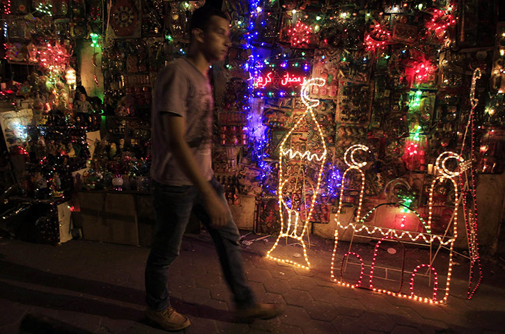 Ramadan: A man walks past shops selling festive lights in Cairo