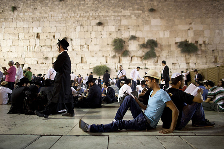 24 hours in pictures: Religious Jews read as they celebrate the festivity of Tisha B'av