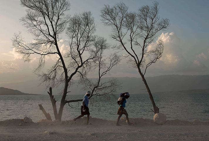 24 hours in pictures: Two women walk next to Lake Azuei , Haiti