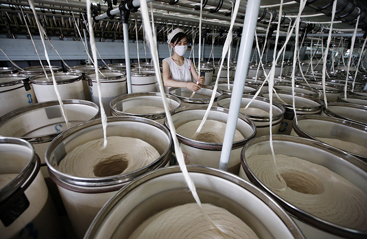 24 hours in pictures: A labourer works at a textile factory in Huaibei, China