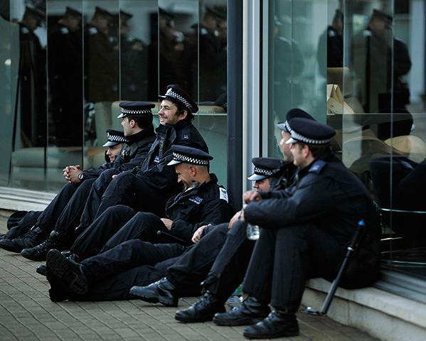 24 hours in pictures: Policemen relax as they rest on a side street in Wandsworth, London