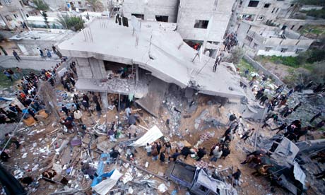 Palestinians inspect a house after it was hit by an Israeli missile a missile in Gaza, March 2008.