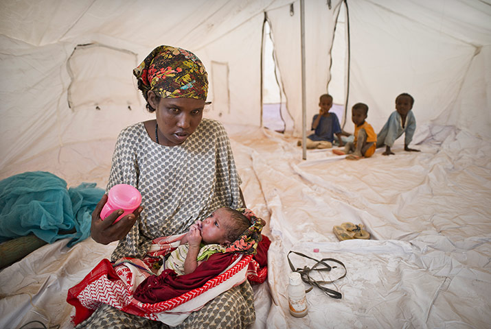 Dadaab camp, Kenya: Mother with her new born in new tent  Dadaab camp, Kenya