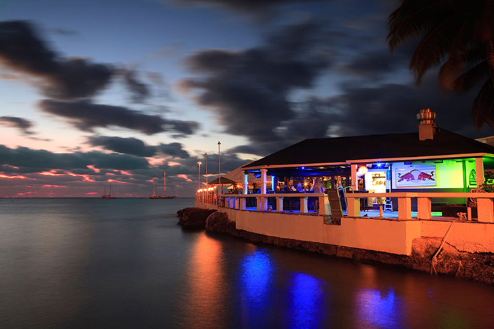 Cayman Islands: A bar on the seafront at sunset in the Cayman Islands