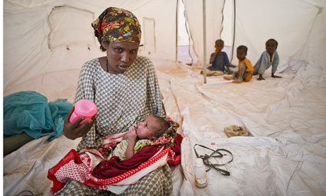 Mother with her new born in new tent in IFO extension, the new camp in Dadaab