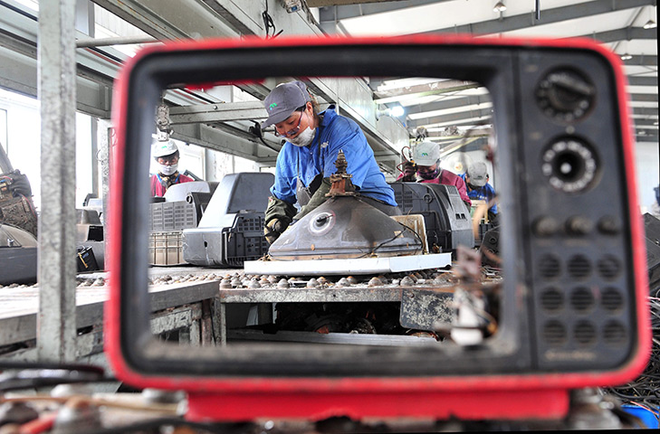 24 hours in pictures: Workers dismantle scrapped electrical goods at a recycling centre, China