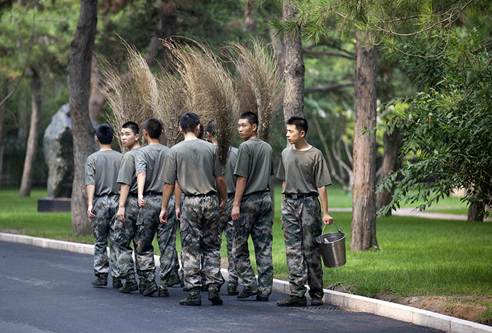 24 hours in pictures: Soldiers go on cleaning duty at the Zhongnanhai leadership compound, China