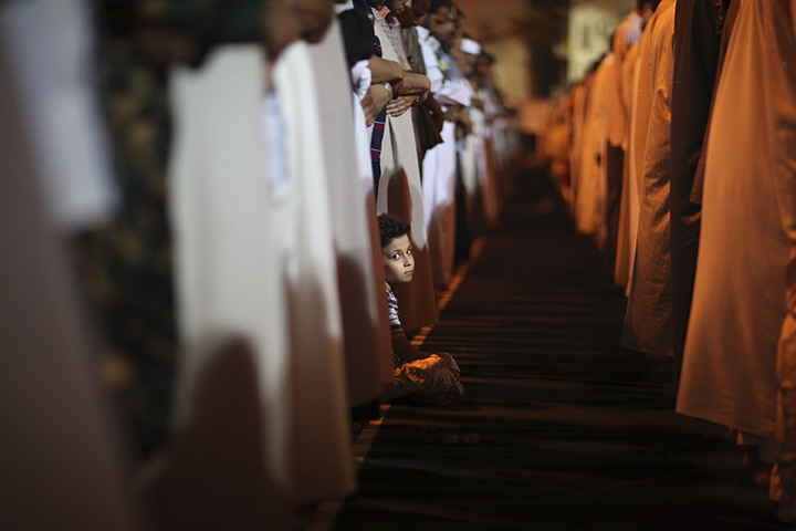 24 hours in pictures: A boy looks on during a pray in a square, Libya
