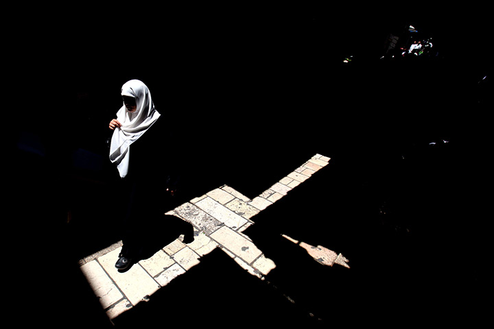 24 hours in pictures: A Palestinian Muslim woman walks on her way to the Al-Aqsa Mosque