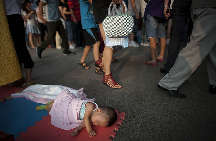 24 hours in pictures: A baby sleeping on the floor as parents queue outside a childrens' hospital