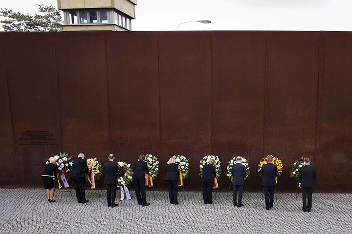 24 Hours: Angela Merkel lays down a floral wreath at the Berlin Wall