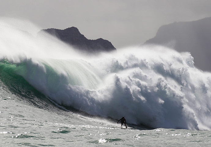 24 hours in pictures: Cape Town, South Africa: Mike Schlebach from South Africa surfs a wave 