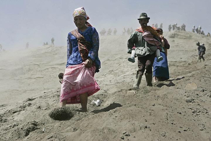 24 hours in pictures: Probolinggo: Villagers walk down the slope of Mount Bromo