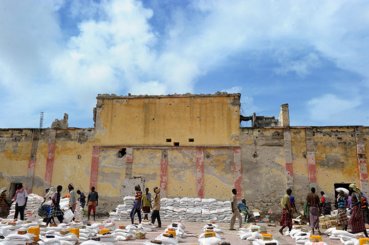 24 hours in pictures: Mogadishu, Somalia: Workers organise piles of food aid