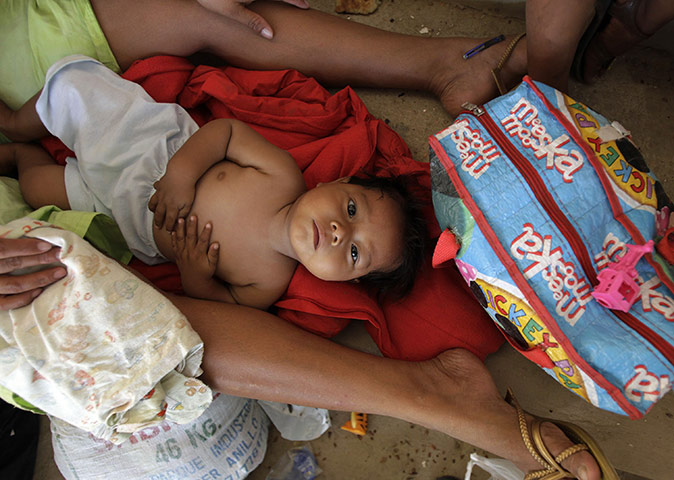 24 hours in pictures: Trinidad, Bolivia: A baby from the Yukis ethnic group rests