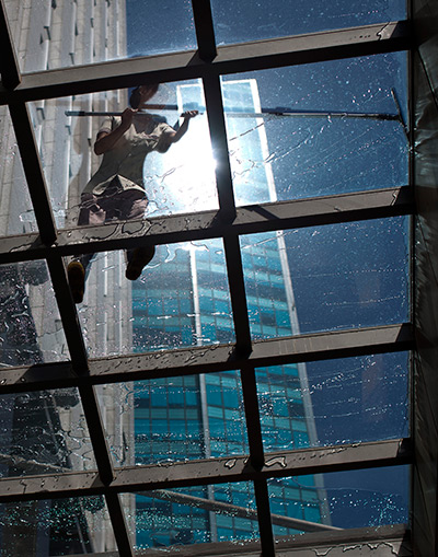 24 hours in pictures: A window washer cleans atop on a structure of glass in Beijing