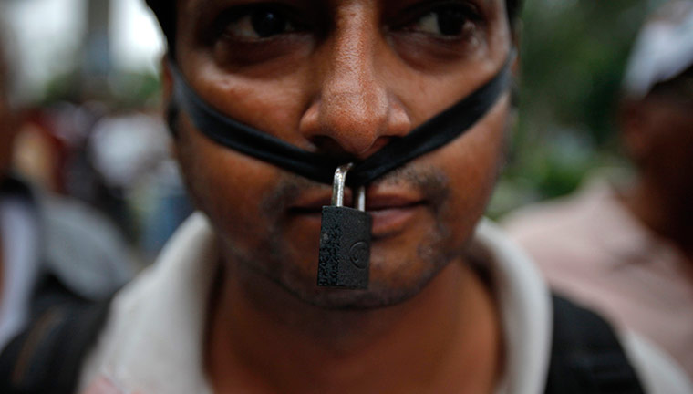Anna Hazare : A supporter of Anna Hazare wears a symbolic lock around his mouth