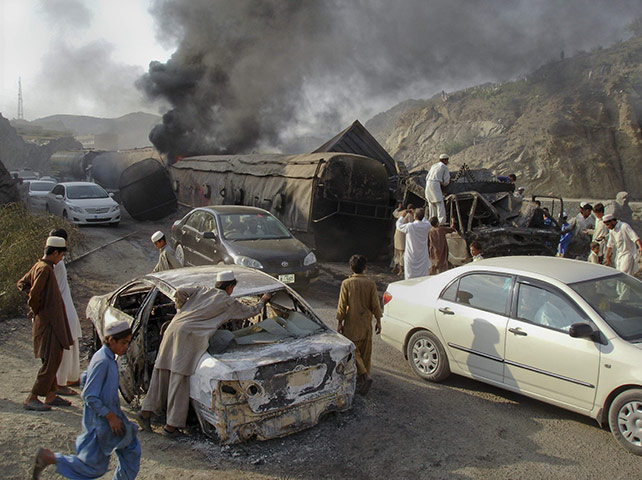 24 hours in pictures: Landikotal, Pakistan: Children try to salvage metal from damaged vehicles 
