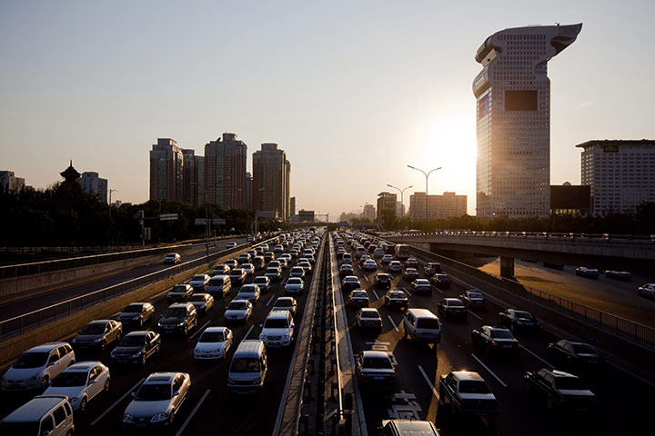 24 hours in pictures: Beijing, China: Traffic runs slow at a congested thoroughfare 