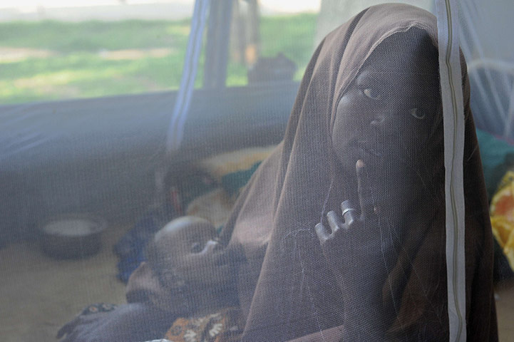 24 hours in pictures: Mogadishu, Somalia: A woman holds her seven-month-old daughter
