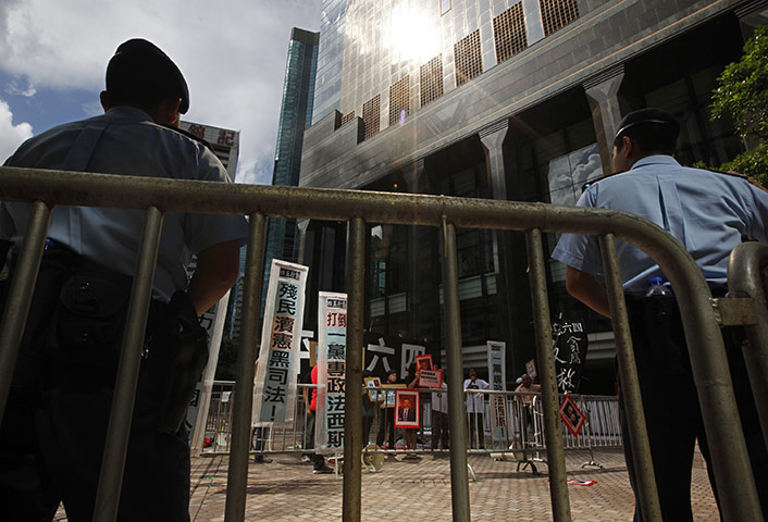 24 hours in pictures: Hong Kong, China: Police officers stand guard against a group of protesters
