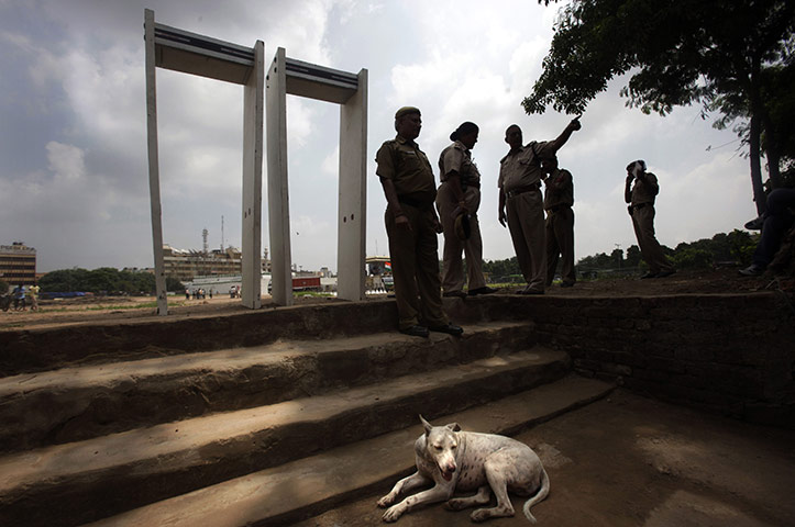 24 hours in pictures: New Delhi, India: Delhi policemen stand near metal detectors