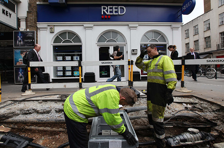 Week in Business: Electricians work outside an employment centre in London