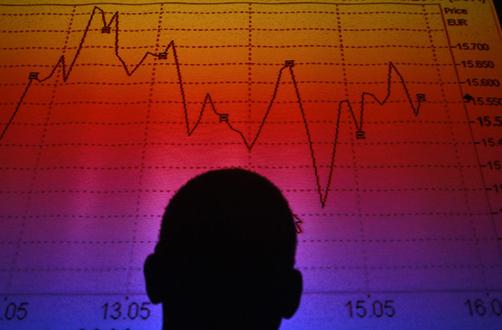 Week in Business: A man is silhouetted in front of the FTSE MIB Index