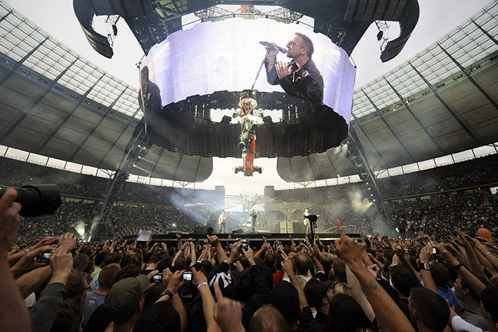 Week in Business: Bono performs on stage during their concert at the Olympic stadium Berlin