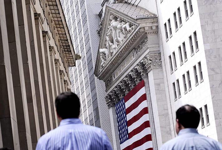 Week in Business: People walk past the New York Stock Exchange in New York