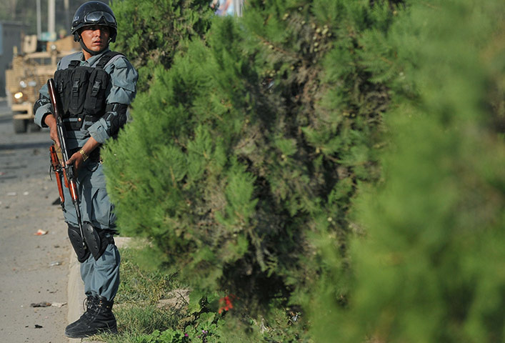 Blast in Kabul: An Afghan policeman takes position