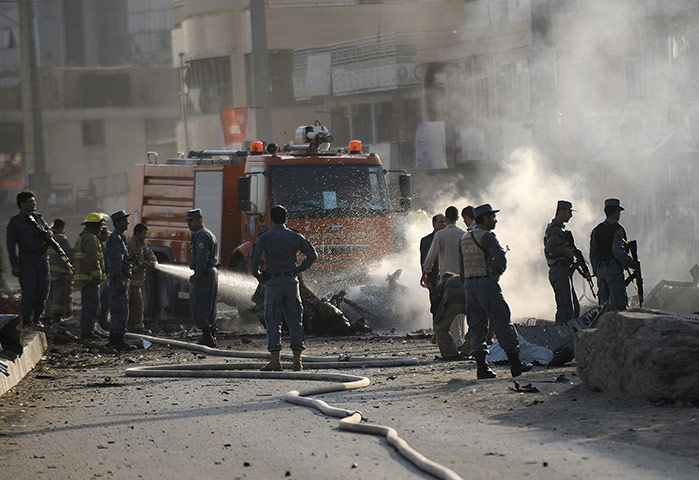 Blast in Kabul: Afghan security personnel and firefighters at the site of the attack
