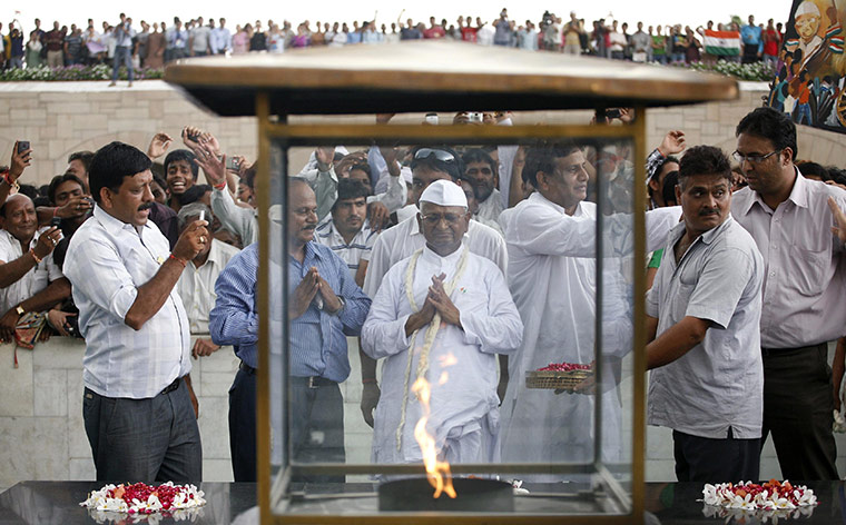 Anna Hazare: Indian social activist Anna Hazare prays at the Mahatma Gandhi memorial 