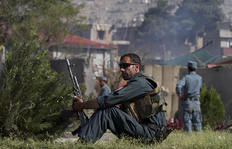 Kabul Attack: An Afghan policeman rests on a foot path after the attack