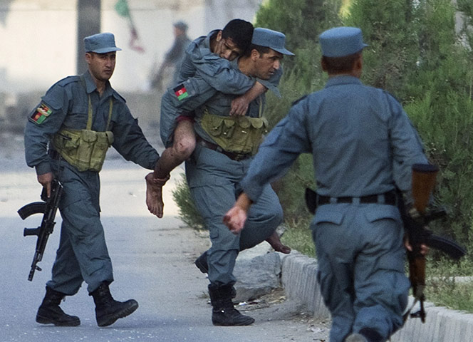 Kabul Attack: A wounded Afghan policeman is carried away