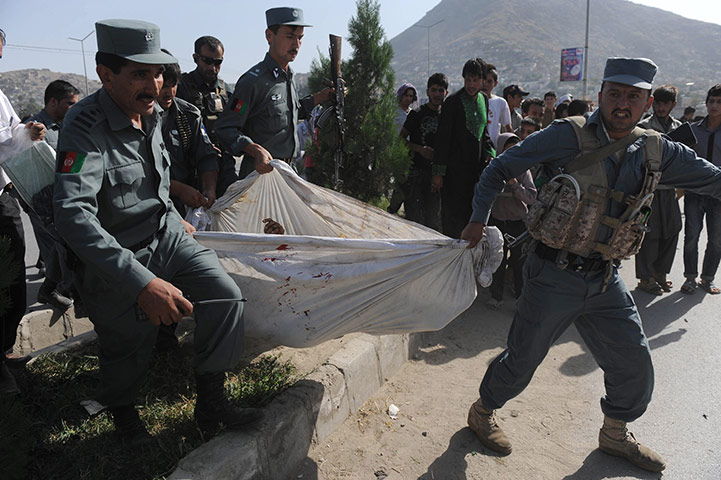 Kabul Attack: Afghanistan's policemen carry the body of a suicide attacker