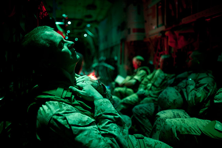 24 hours in pictures: US Marines sleep on a transport flight, Afghanistan